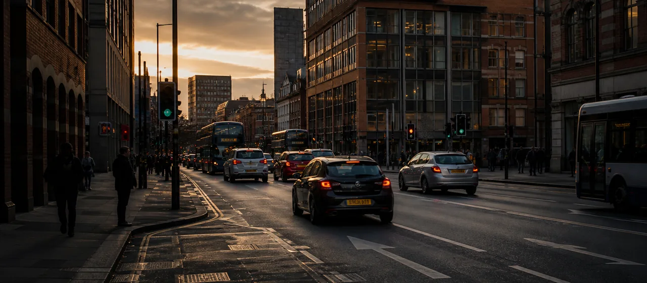 Busy urban road in a Greater Manchester city setting at golden hour