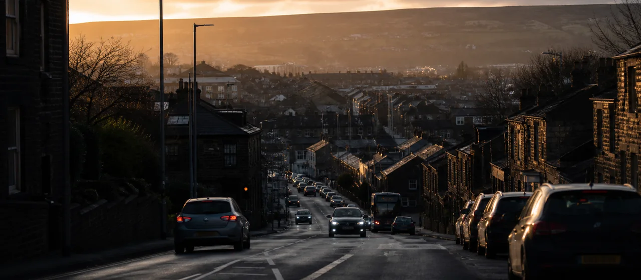 Hilly Oldham-style urban road with ordinary town traffic