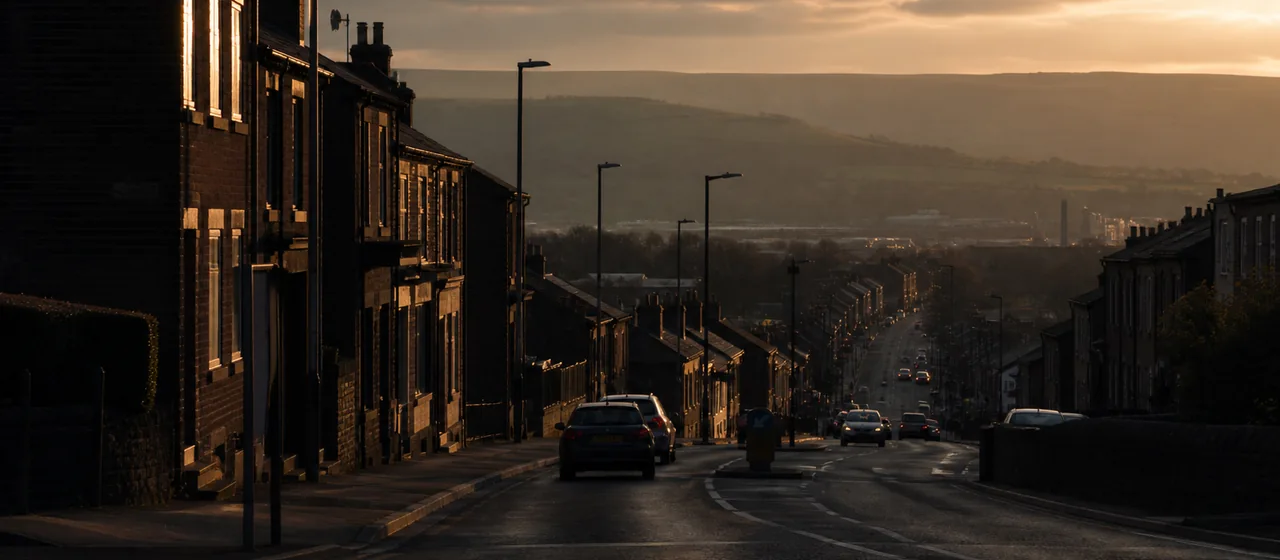 Rochdale-style town-edge road opening toward distant hills
